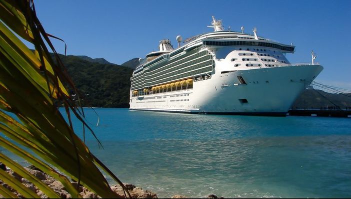cruise ship with beach in foreground